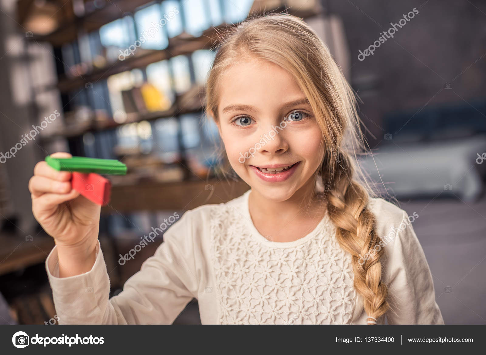 Girl playing with plasticine Stock Photo by ©IgorTishenko 137334400