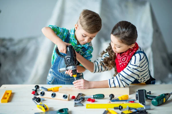 Boy and girl with tools — Stock Photo, Image