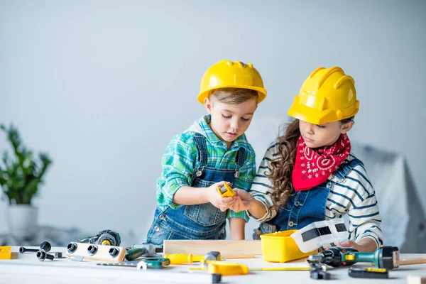 Boy and girl with tools — Stock Photo, Image