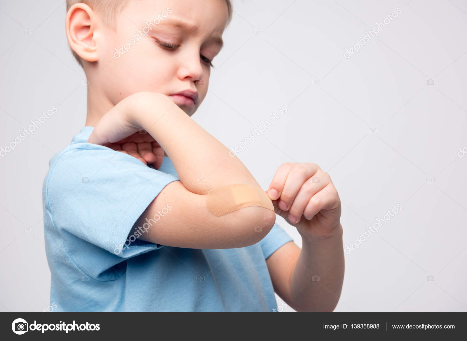 Little boy with patch on elbow — Stock Photo © IgorTishenko 139358988