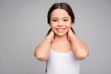 Little girl with patches on elbows clipart
