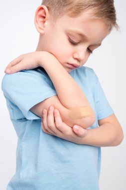 Little boy with patch on elbow