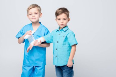 Kids playing doctor and patient clipart