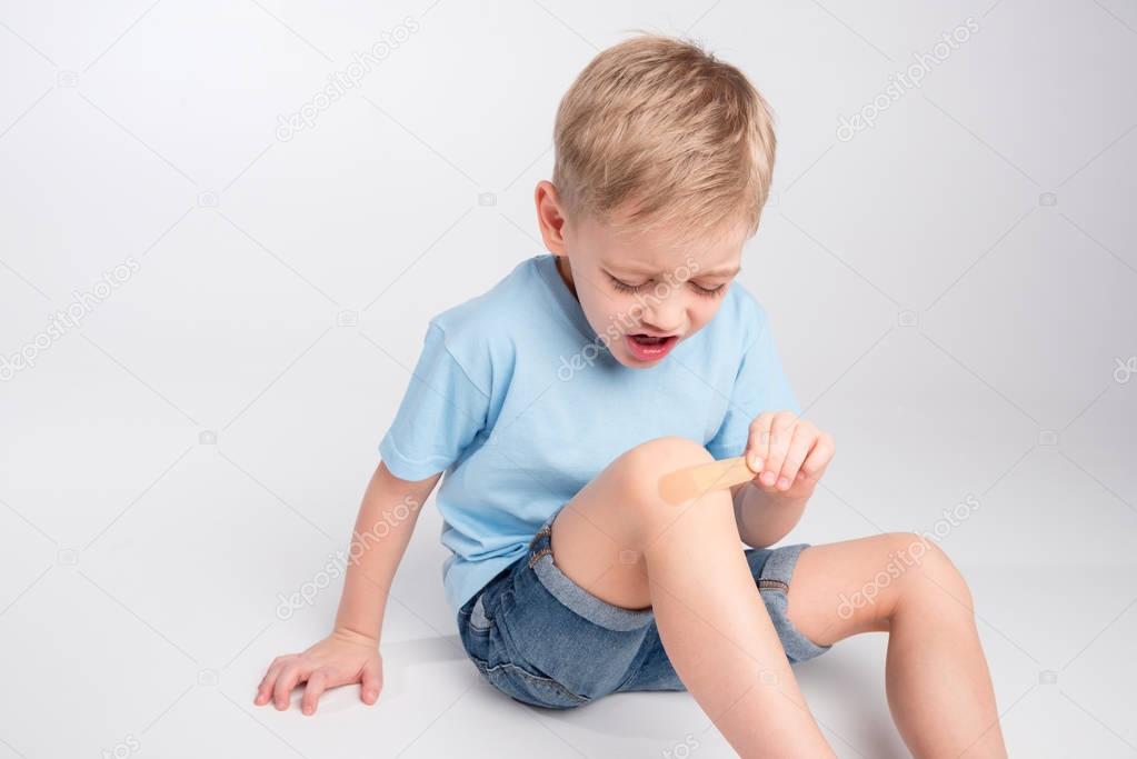 Little boy with patch on knee