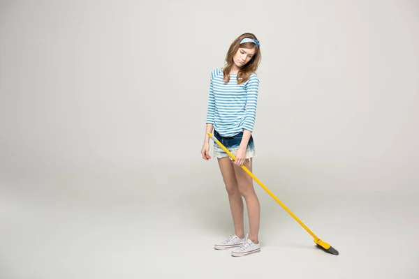 Young woman with broom — Stock Photo, Image