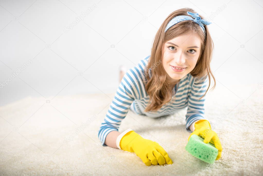 Woman cleaning carpet 