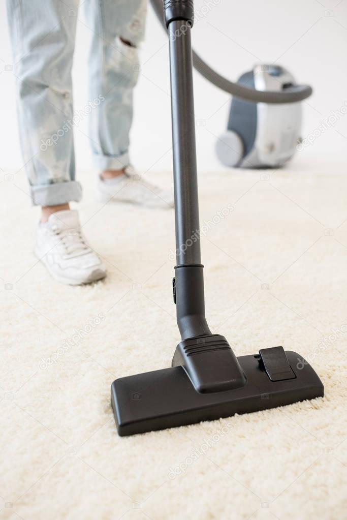 Woman vacuuming carpet