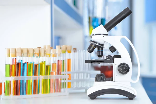 Laboratory tubes and microscope — Stock Photo, Image