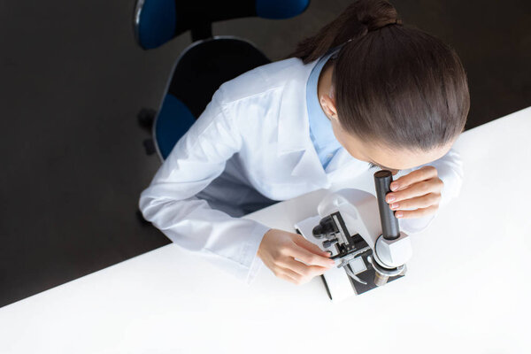 scientist working with microscope