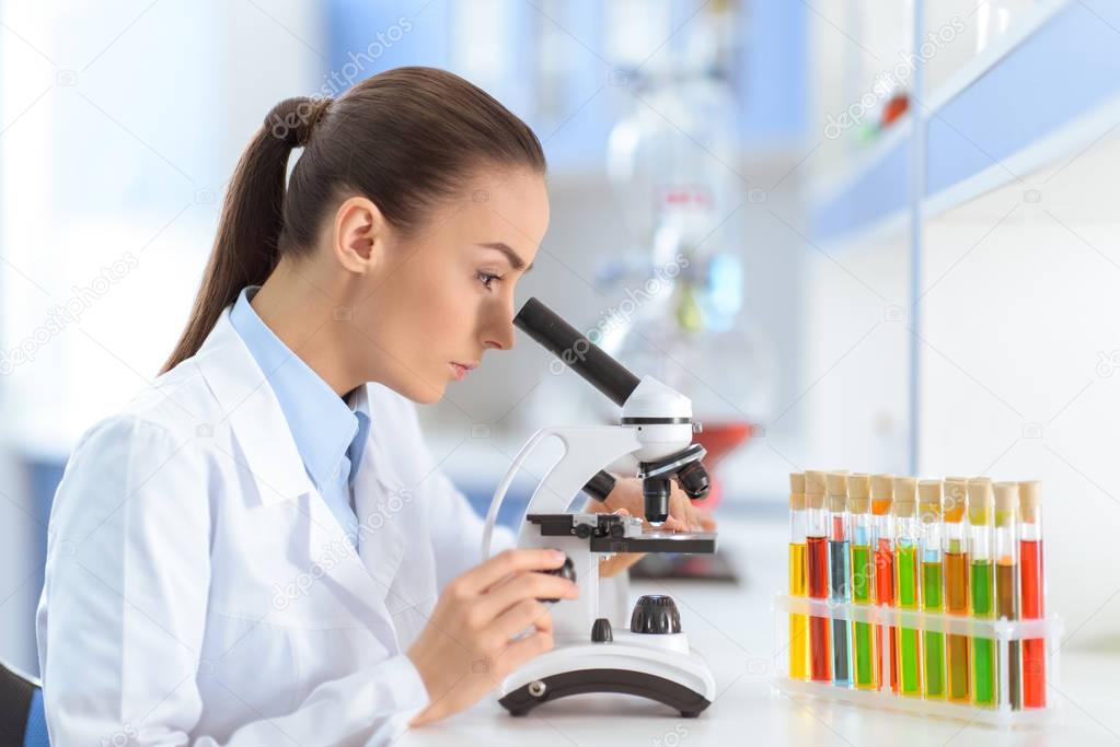 Scientist working with microscope