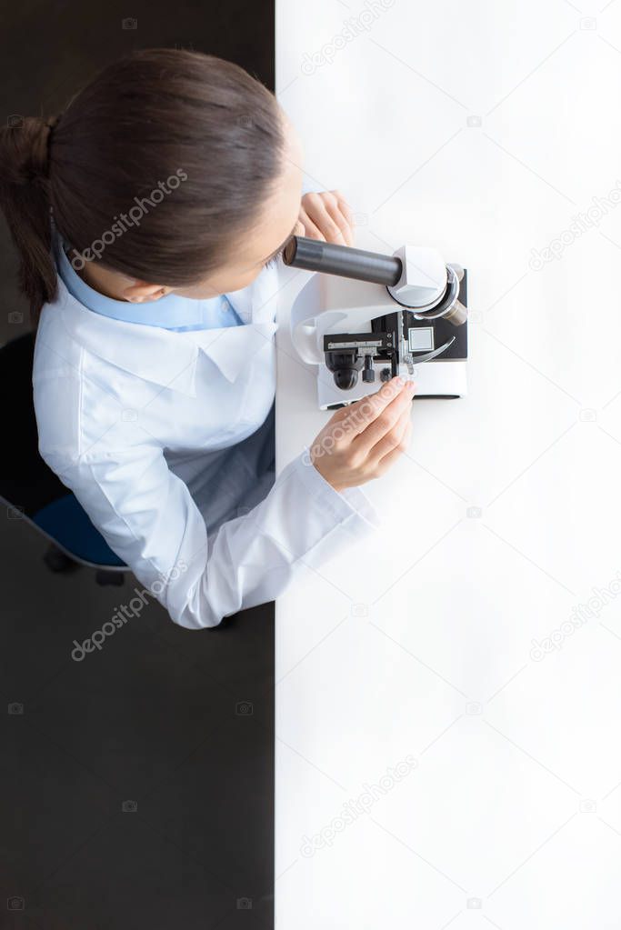 scientist working with microscope