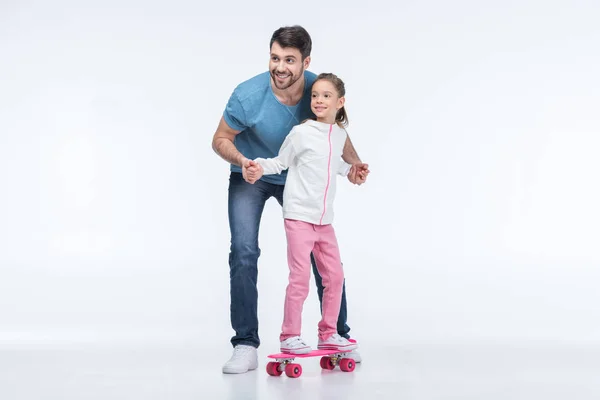 Father and daughter with skateboard — Stock Photo, Image