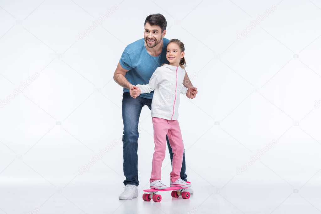 father and daughter with skateboard