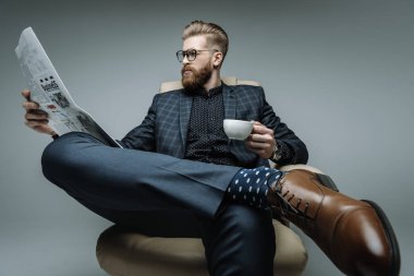 stylish businessman sitting in armchair