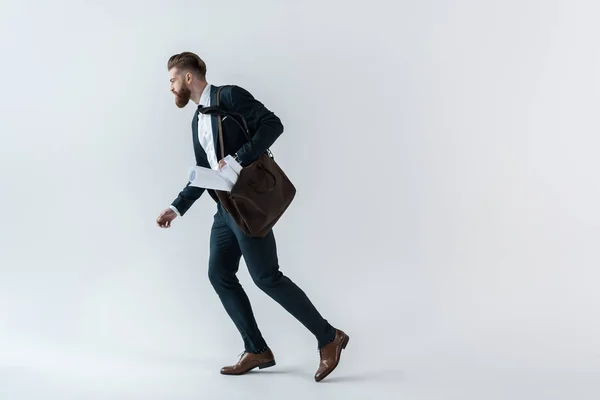 Joven hombre de negocios con planos — Foto de Stock