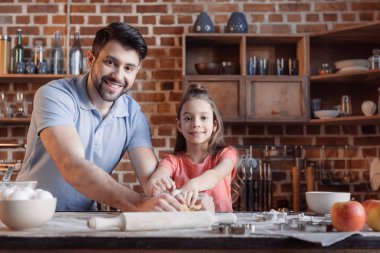 Father and daughter cooking together clipart