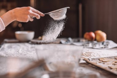 Hand sifting flour