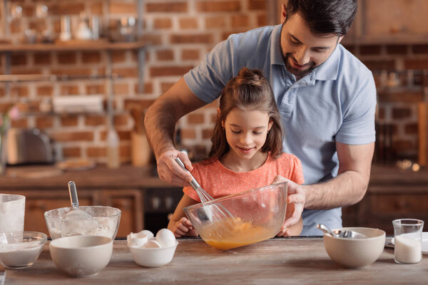 father and daughter cooking