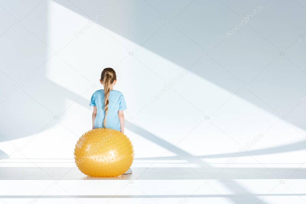 Girl exercising on fitness ball