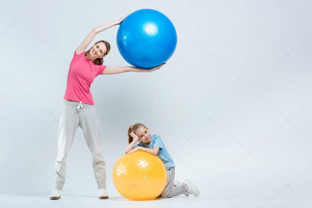 mother and daughter with fitness balls