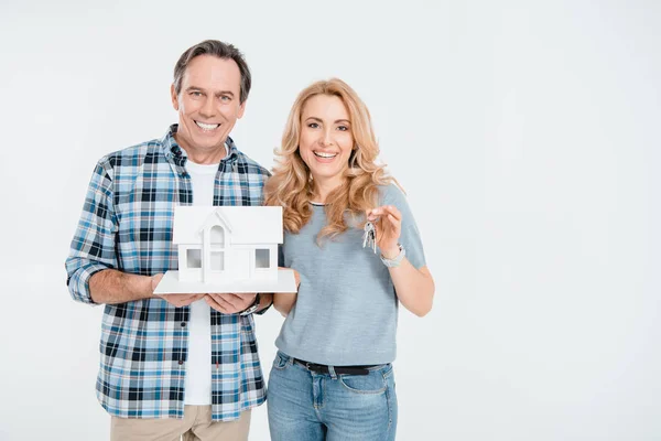Couple holding house model — Stock Photo, Image