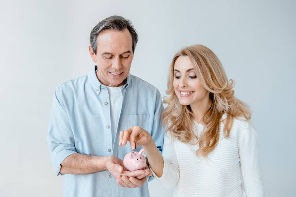 Mature couple with piggy bank 