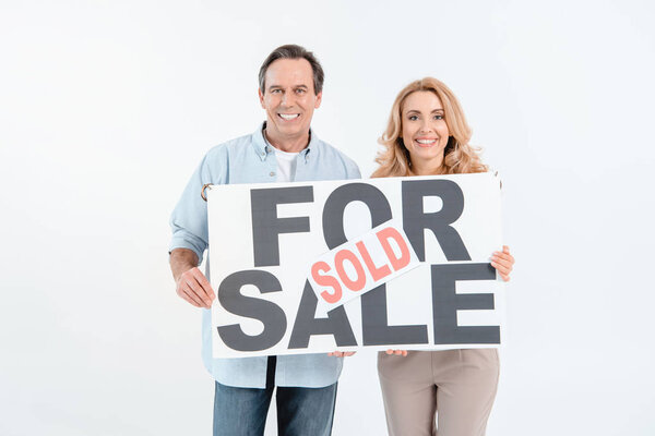 Couple holding signboard 