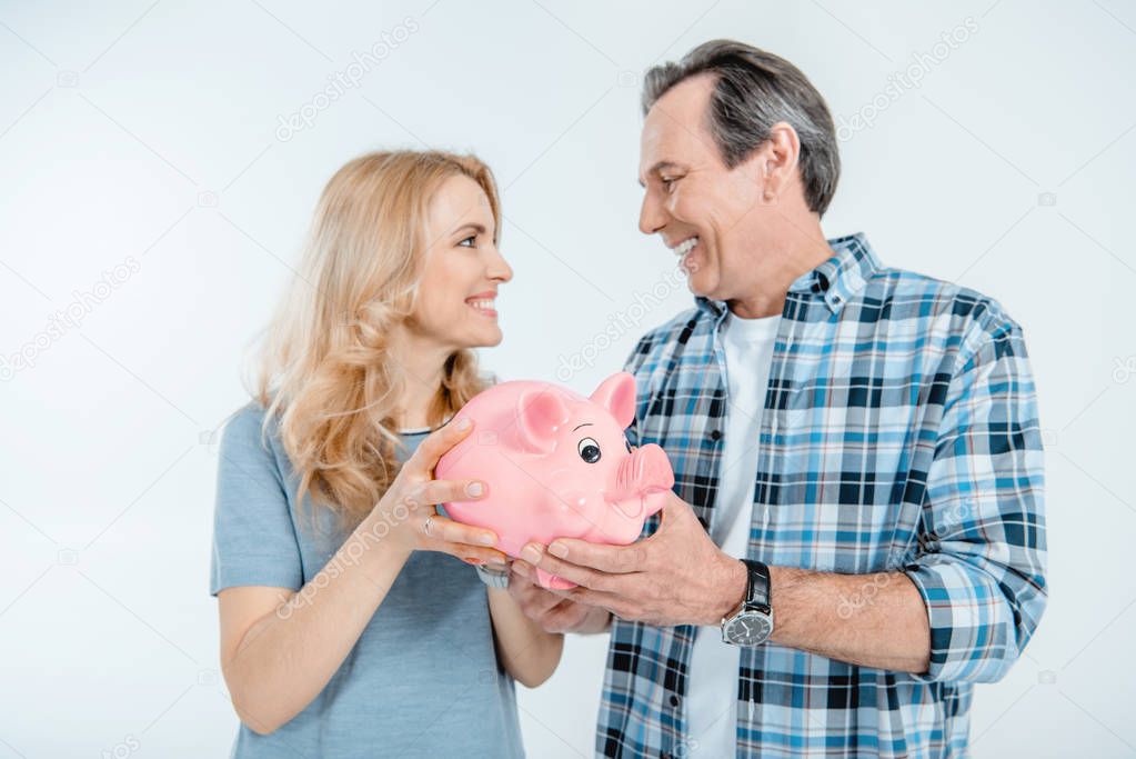 Couple holding piggy bank 