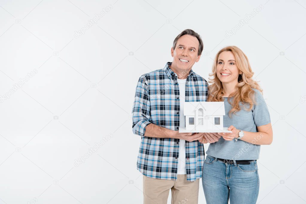 Couple holding house model