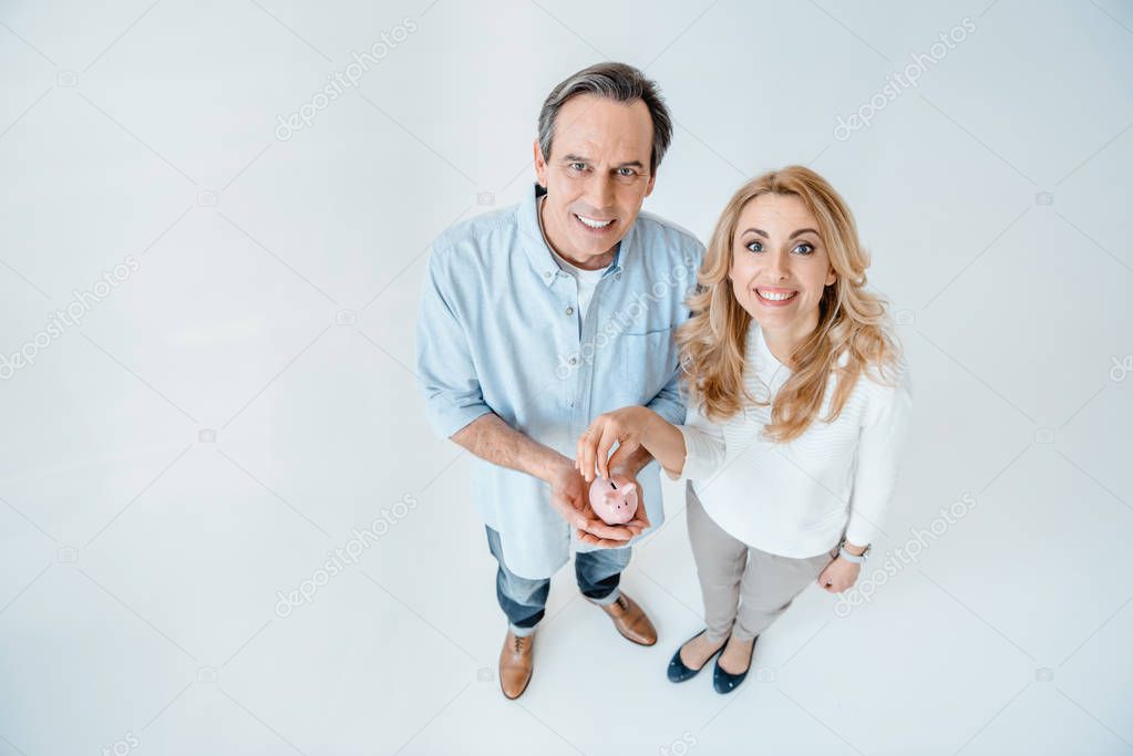 Mature couple with piggy bank 