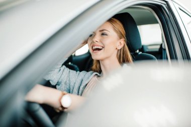 Woman sitting in new car 