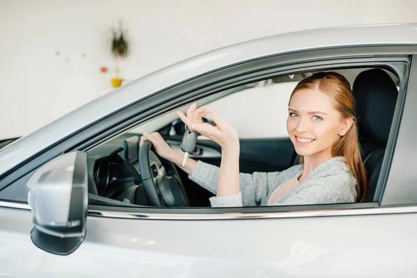 Woman sitting in new car — Stock Photo, Image