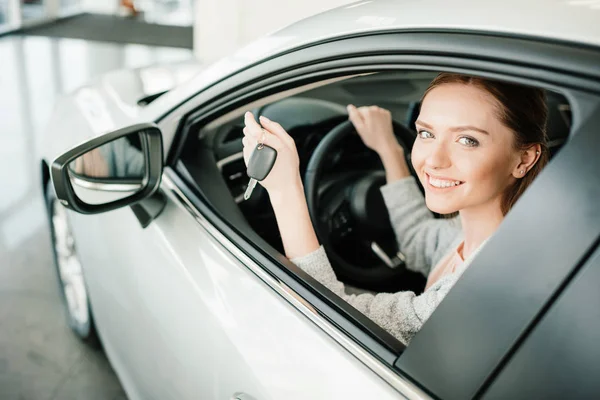 Frau sitzt in neuem Auto — Stockfoto