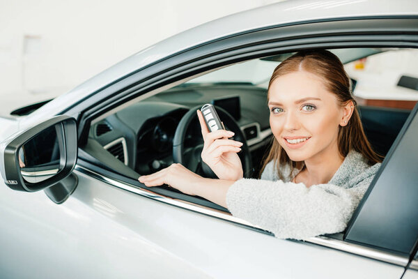 Женщина сидит в новой машине
 