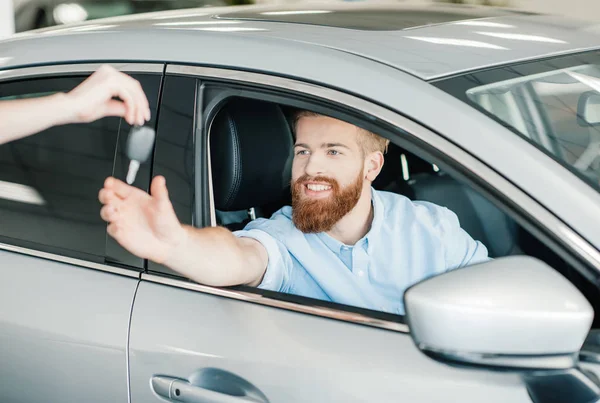 Man sitting in new car — Stock Photo, Image