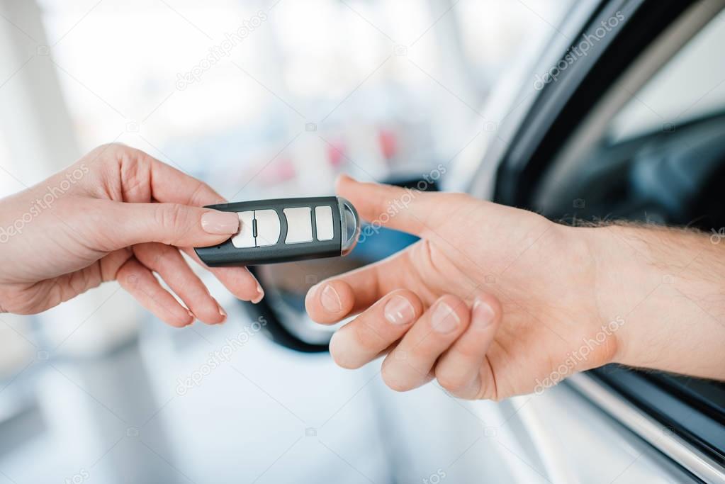 Customer and salesman with car key  