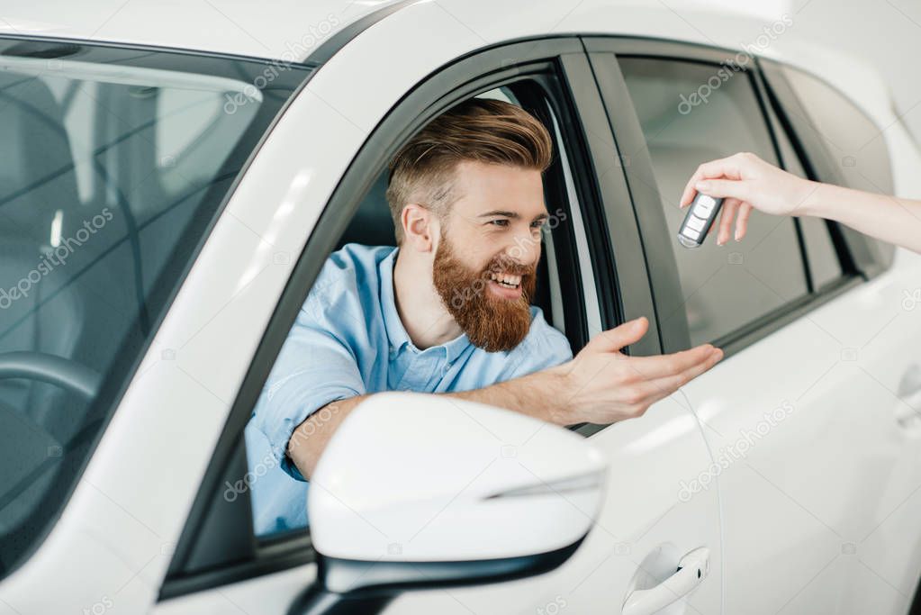 Man sitting in new car 