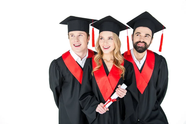 Glada studenter i mortarboards — Stockfoto