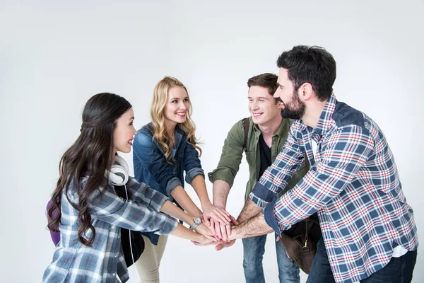 Students stacking hands — Stock Photo, Image