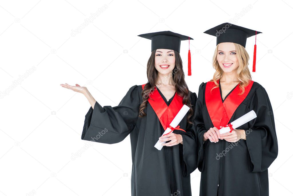 Happy students with diplomas 