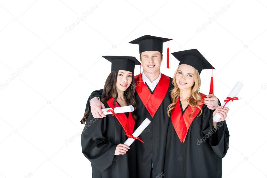 Happy students with diplomas 