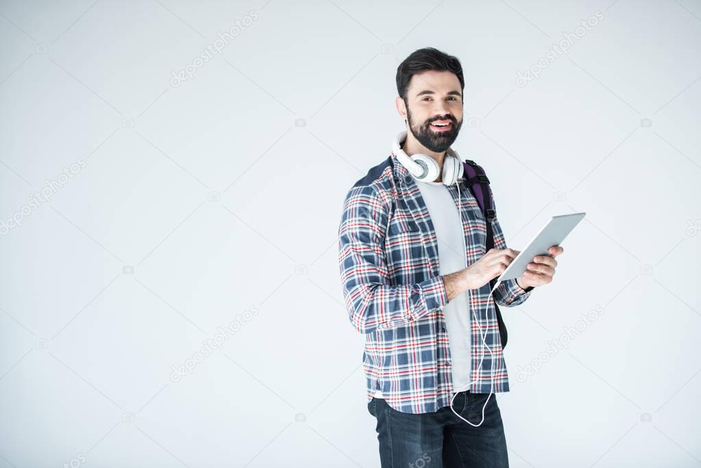 man with headphones and digital tablet