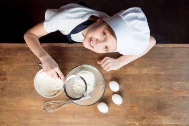 boy making dough for cookies clipart