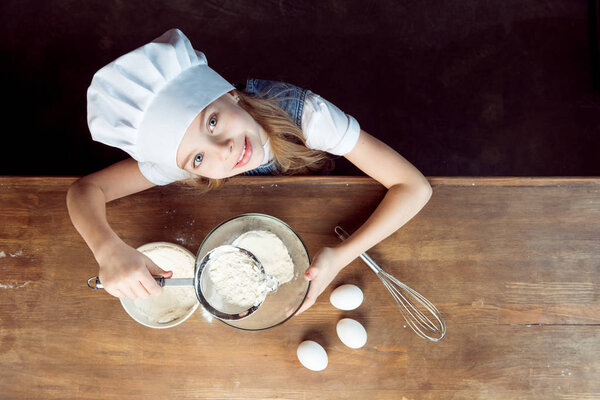 girl making dough for cookies