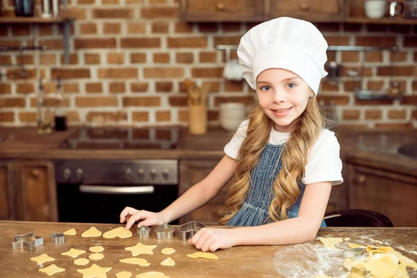 Girl making shaped cookies — Stock Photo, Image