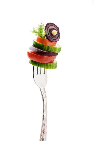 sliced vegetables on fork