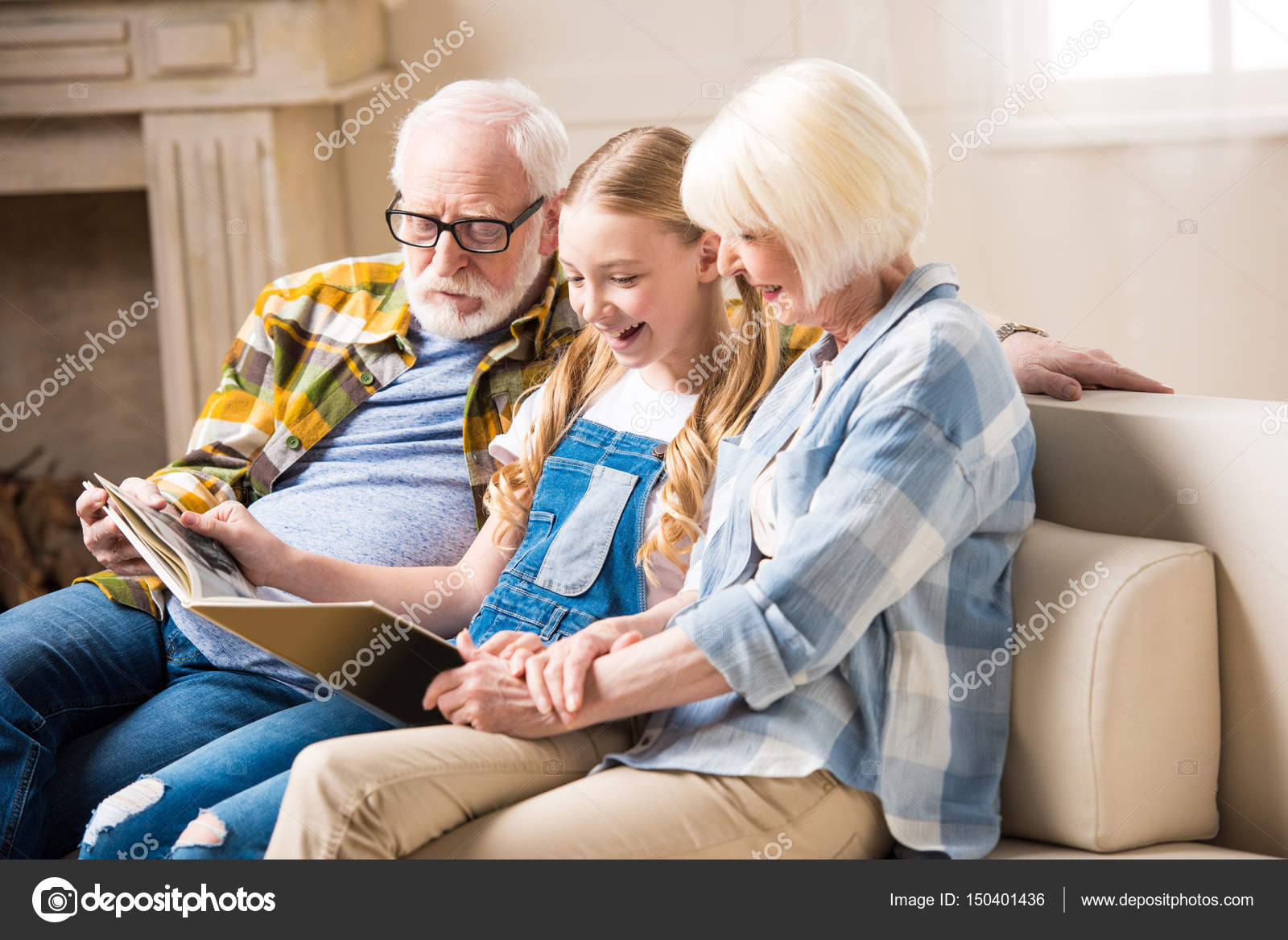 Grandparents and child with photo album — Stock Photo © IgorTishenko