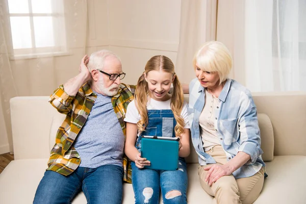 Grandparents and child with digital tablet — Stock Photo, Image