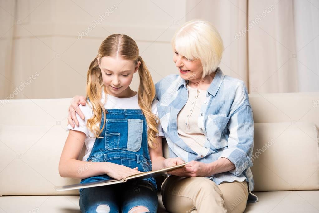 Grandmother and girl with photo album