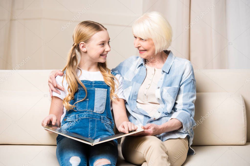 Grandmother and girl with photo album